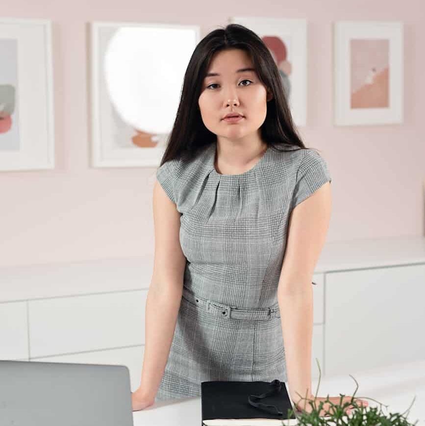 a pretty woman in a grey dress